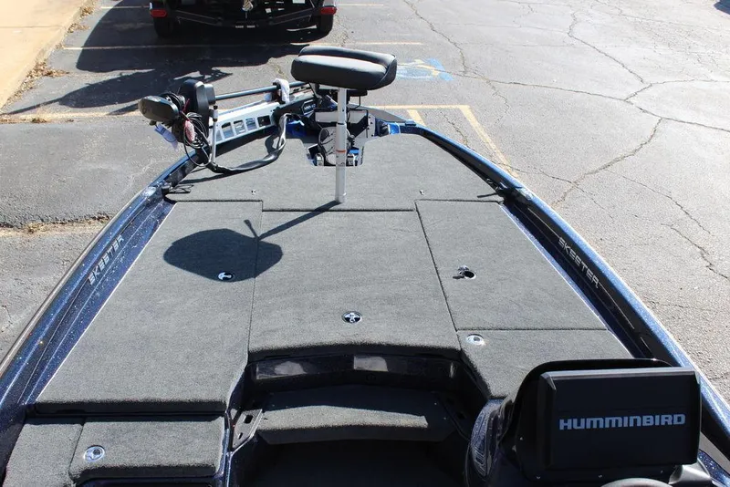 Slide: The Image of 2025 Skeeter ZXR20 fishing boat deck with Humminbird electronics, parked on asphalt. - 13