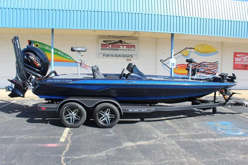 Slide: The Image of 2025 Skeeter ZXR20 boat on trailer, parked outside dealership. - 3