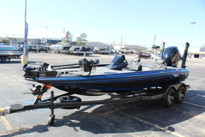 Slide: The Image of 2025 Skeeter ZXR20 bass boat on trailer in parking lot. - 7