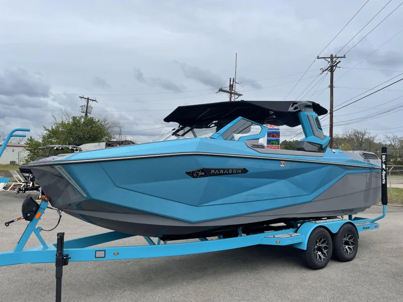 Slide: The Image of 2024 Nautique Super Air Nautique G23 Paragon in blue on trailer, parked outdoors. - 1