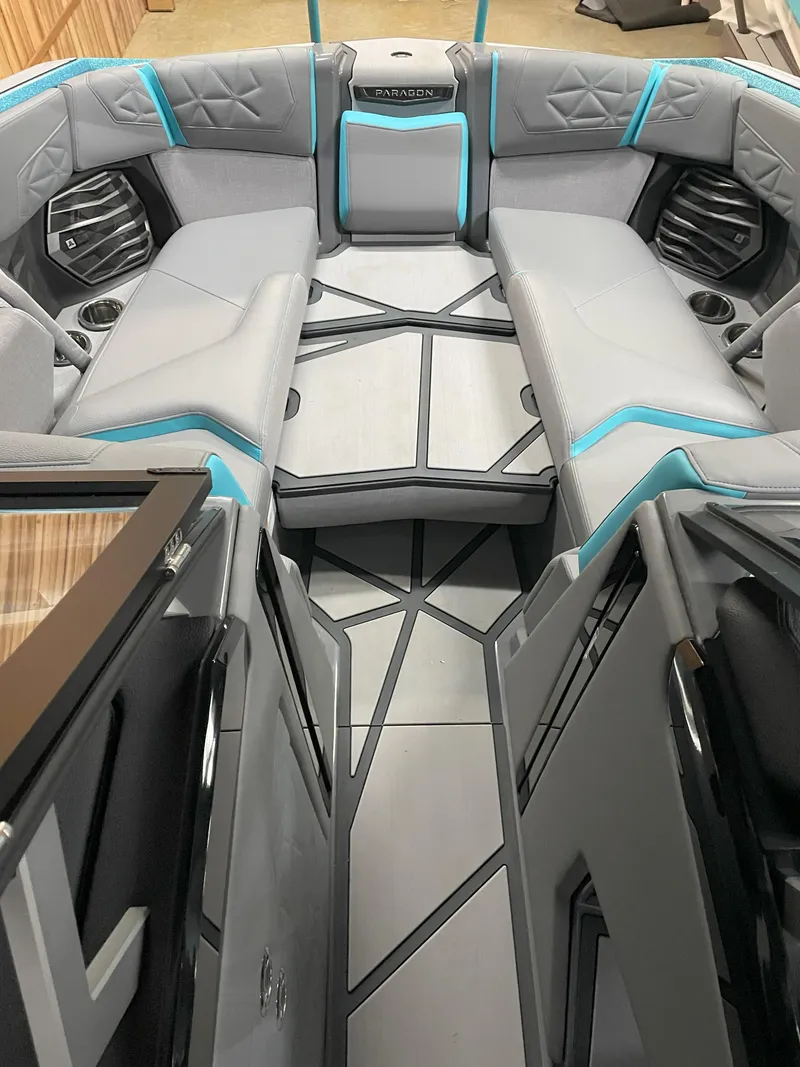 Slide: The Image of 2024 Nautique Super Air Nautique G23 Paragon interior with gray and blue seating. - 10