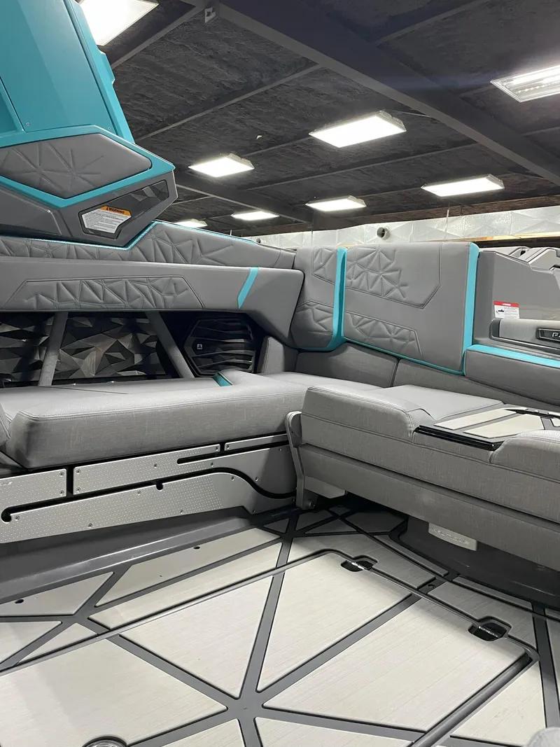 Slide: The Image of 2024 Nautique Super Air Nautique G23 Paragon interior with modern gray and teal seating. - 11