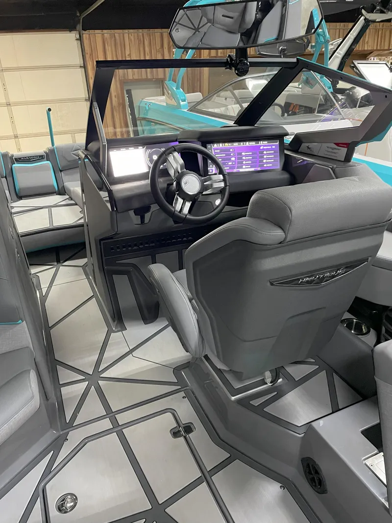 Slide: The Image of 2024 Nautique Super Air Nautique G23 Paragon interior with modern dashboard and seating. - 13