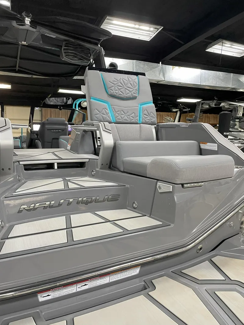 Slide: The Image of 2024 Nautique Super Air Nautique G23 Paragon interior with sleek gray seating and modern design. - 20