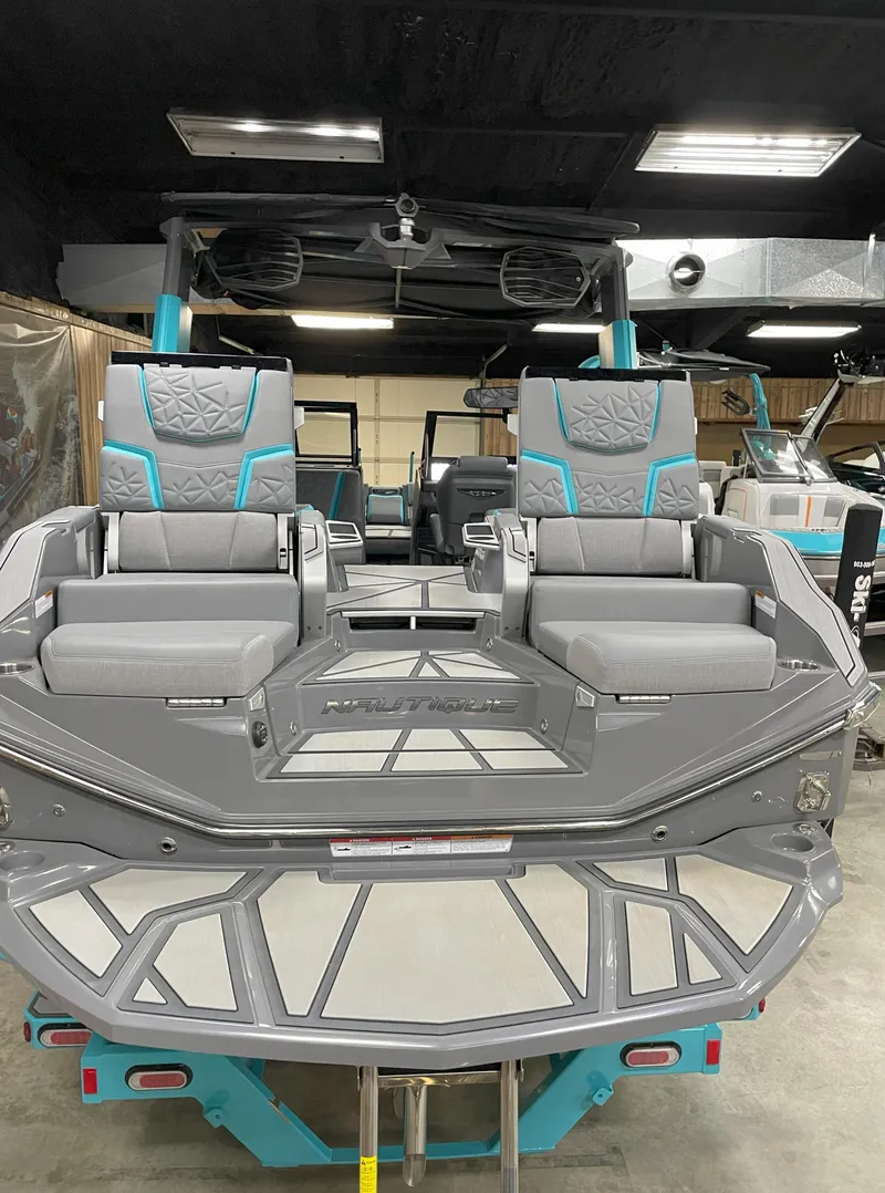 Slide: The Image of 2024 Nautique Super Air Nautique G23 Paragon boat interior with gray and teal seating. - 21