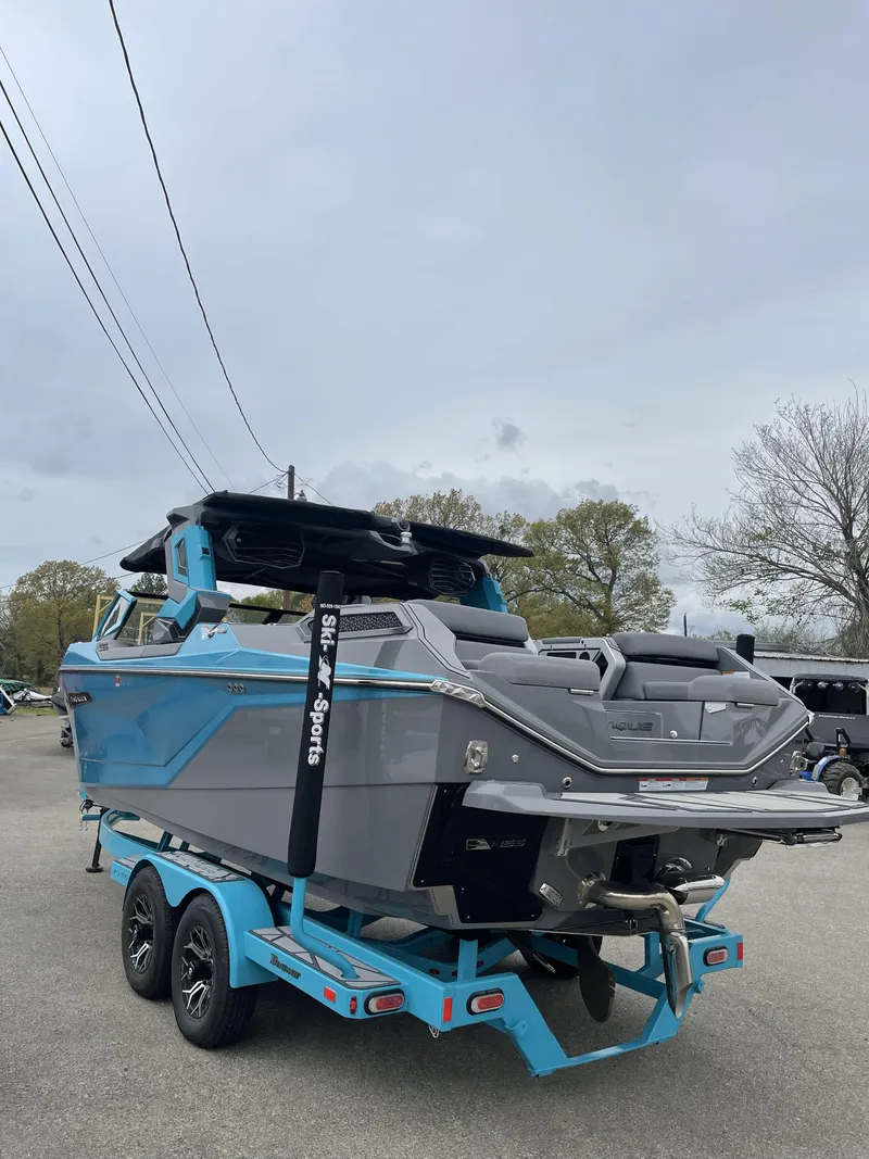 Slide: The Image of 2024 Nautique Super Air Nautique G23 Paragon boat on trailer, blue and gray design. - 3