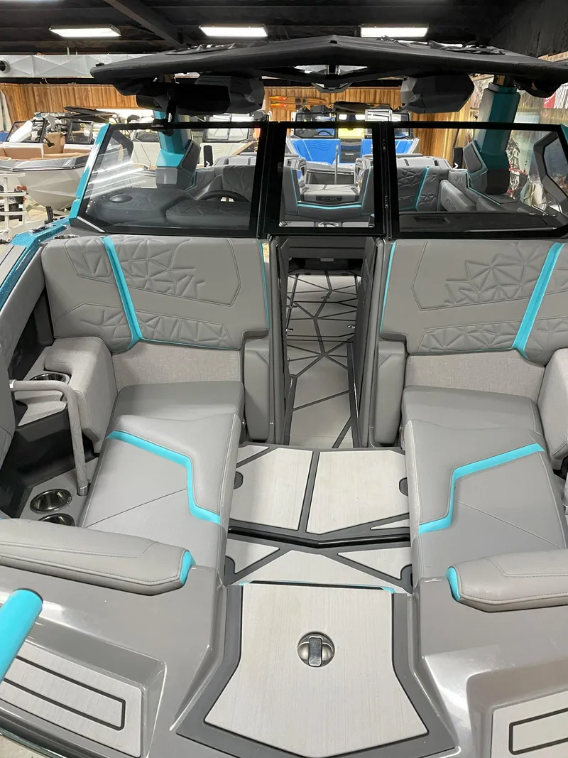 Slide: The Image of 2024 Nautique Super Air Nautique G23 Paragon interior with gray and teal seating. - 5