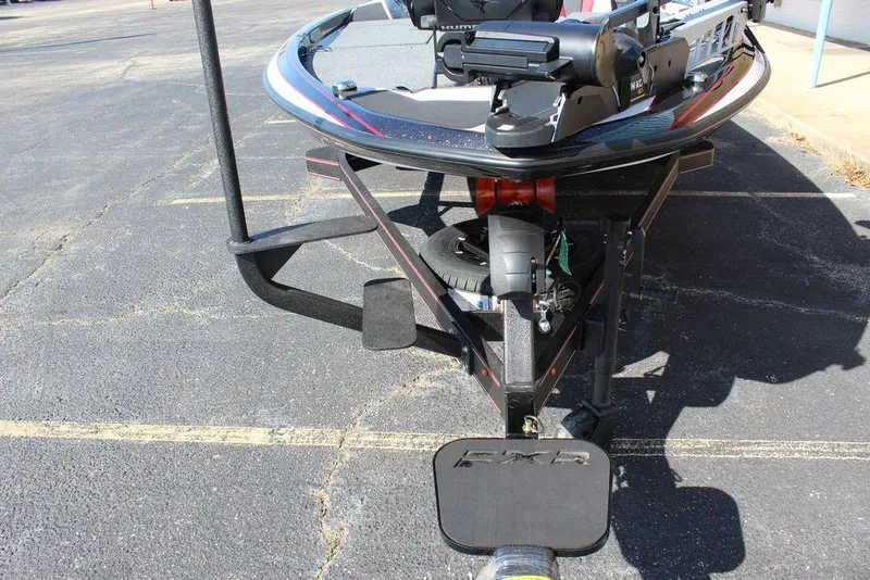 Slide: The Image of 2025 Skeeter FXR21L boat trailer with sleek design on asphalt surface. - 12