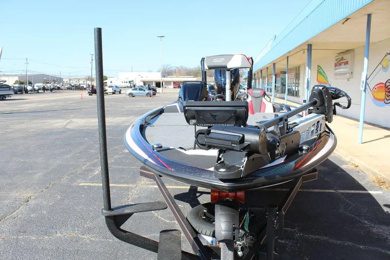 Slide: The Image of 2025 Skeeter FXR21L bass boat parked in a lot, showcasing advanced fishing equipment. - 13