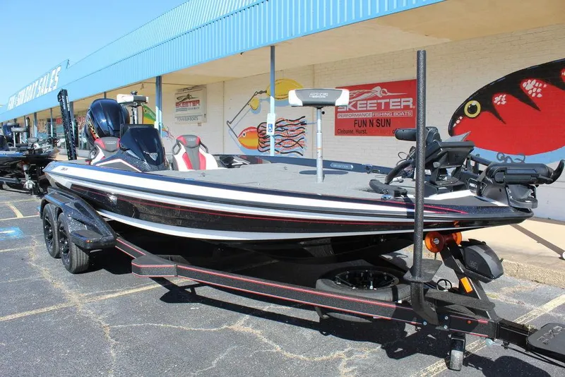 Slide: The Image of 2025 Skeeter FXR21L bass boat on trailer outside dealership. - 14