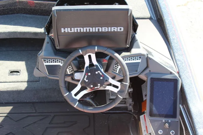 Slide: The Image of 2025 Skeeter FXR21L boat dashboard with Humminbird display and steering wheel. - 19