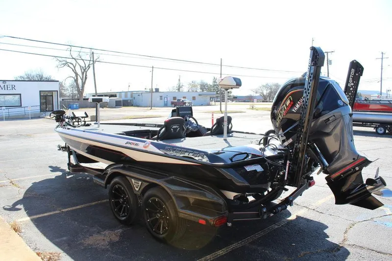 Slide: The Image of 2025 Skeeter FXR21L bass boat with powerful outboard motor, parked on a trailer. - 6