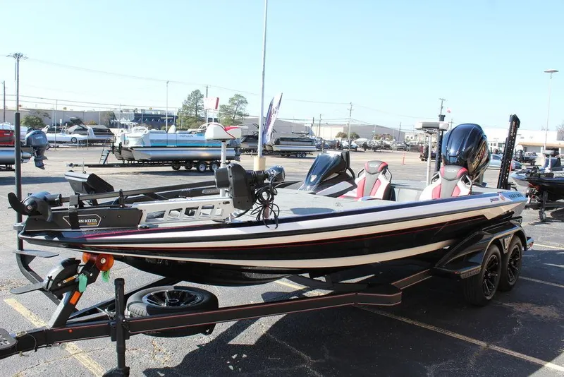 Slide: The Image of 2025 Skeeter FXR21L bass boat displayed in a parking lot. - 9