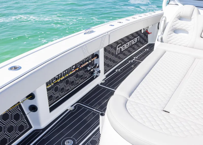 Slide: The Image of Freeman 42 LR 2019 boat interior with sleek seating and modern design on the water. - 11