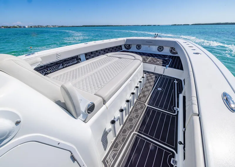 Slide: The Image of 2019 Freeman 42 LR boat with spacious seating on clear blue water. - 12
