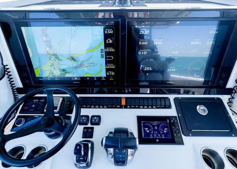 Slide: The Image of Control panel of a 2019 Freeman 42 LR boat with navigation screens and steering wheel. - 17