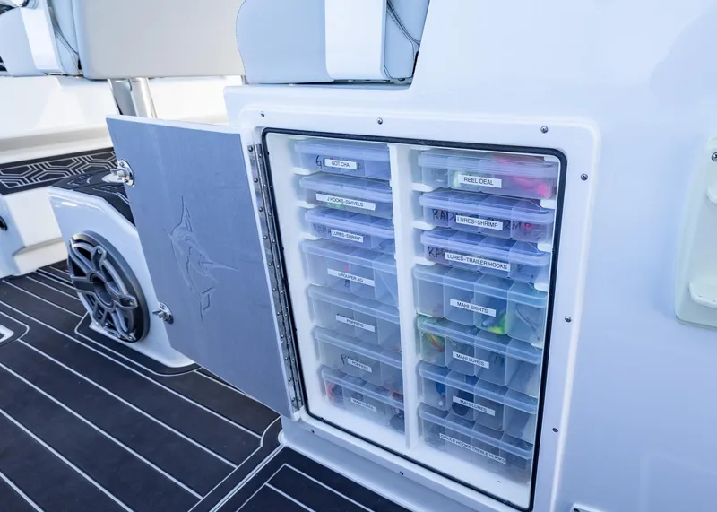 Slide: The Image of Tackle storage compartment on a 2019 Freeman 42 LR boat, featuring organized fishing gear. - 22
