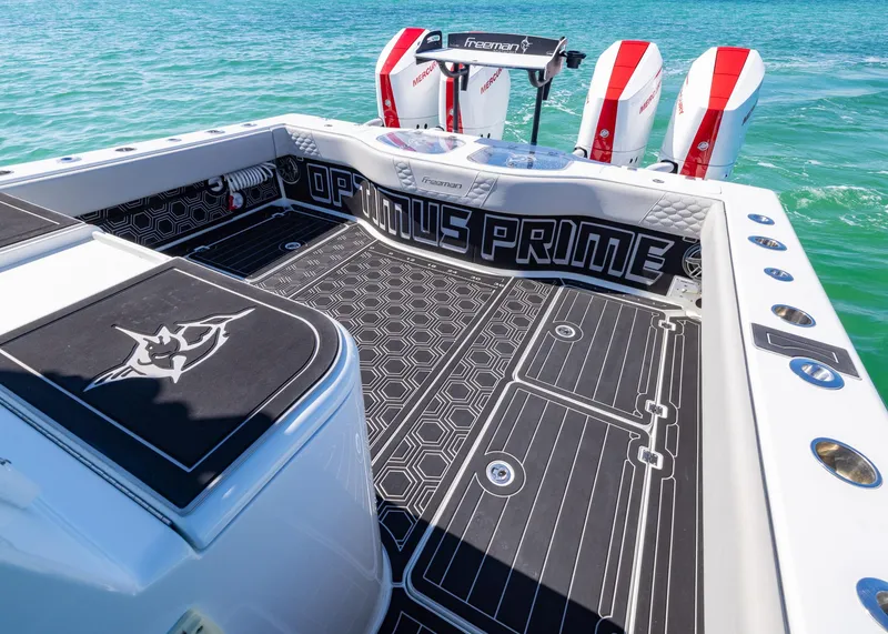 Slide: The Image of 2019 Freeman 42 LR boat deck with custom "Optimus Prime" design, featuring twin engines. - 26