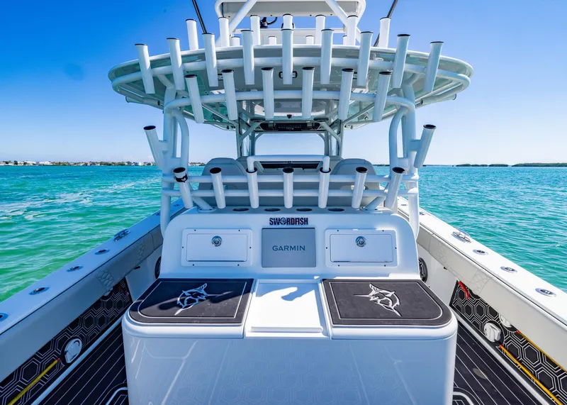 Slide: The Image of 2019 Freeman 42 LR boat with rod holders, Garmin equipment, on clear blue water. - 28