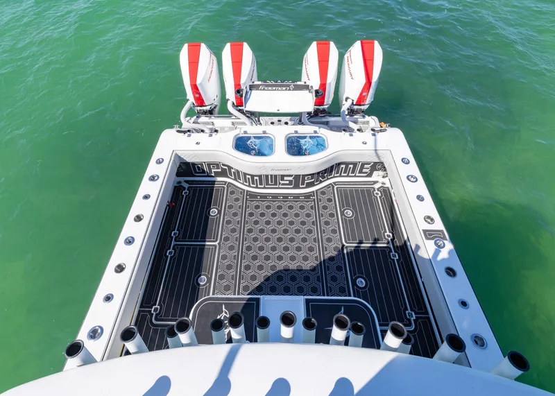 Slide: The Image of 2019 Freeman 42 LR boat with triple engines on turquoise water. - 31