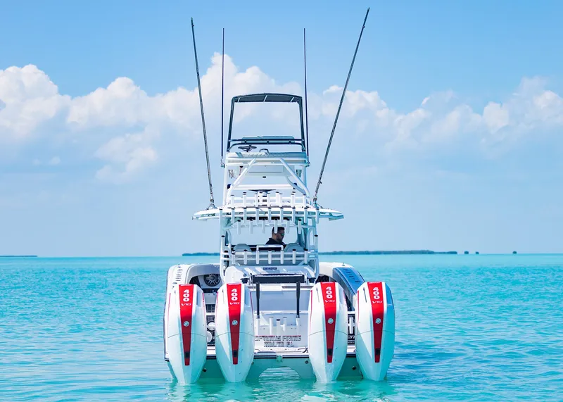 Slide: The Image of 2019 Freeman 42 LR boat with four engines on turquoise water under blue sky. - 38