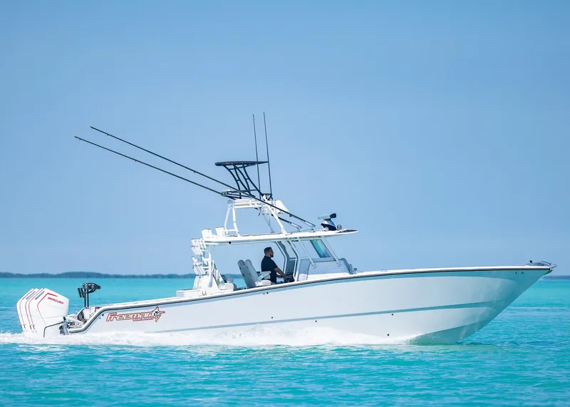 Slide: The Image of 2019 Freeman 42 LR boat cruising on clear turquoise water. - 41