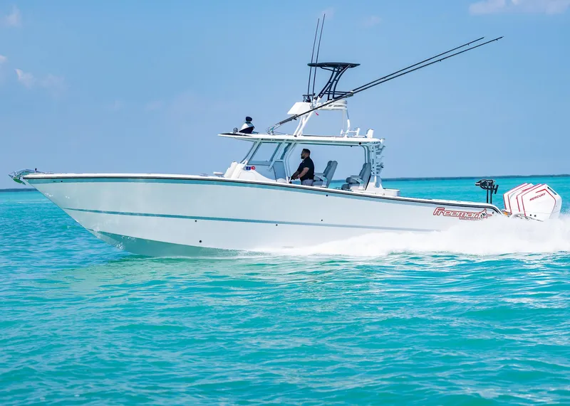 Slide: The Image of 2019 Freeman 42 LR boat cruising on clear turquoise water. - 42