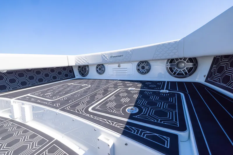 Slide: The Image of Freeman 42 LR 2019 boat deck with geometric design and speakers under clear blue sky. - 7