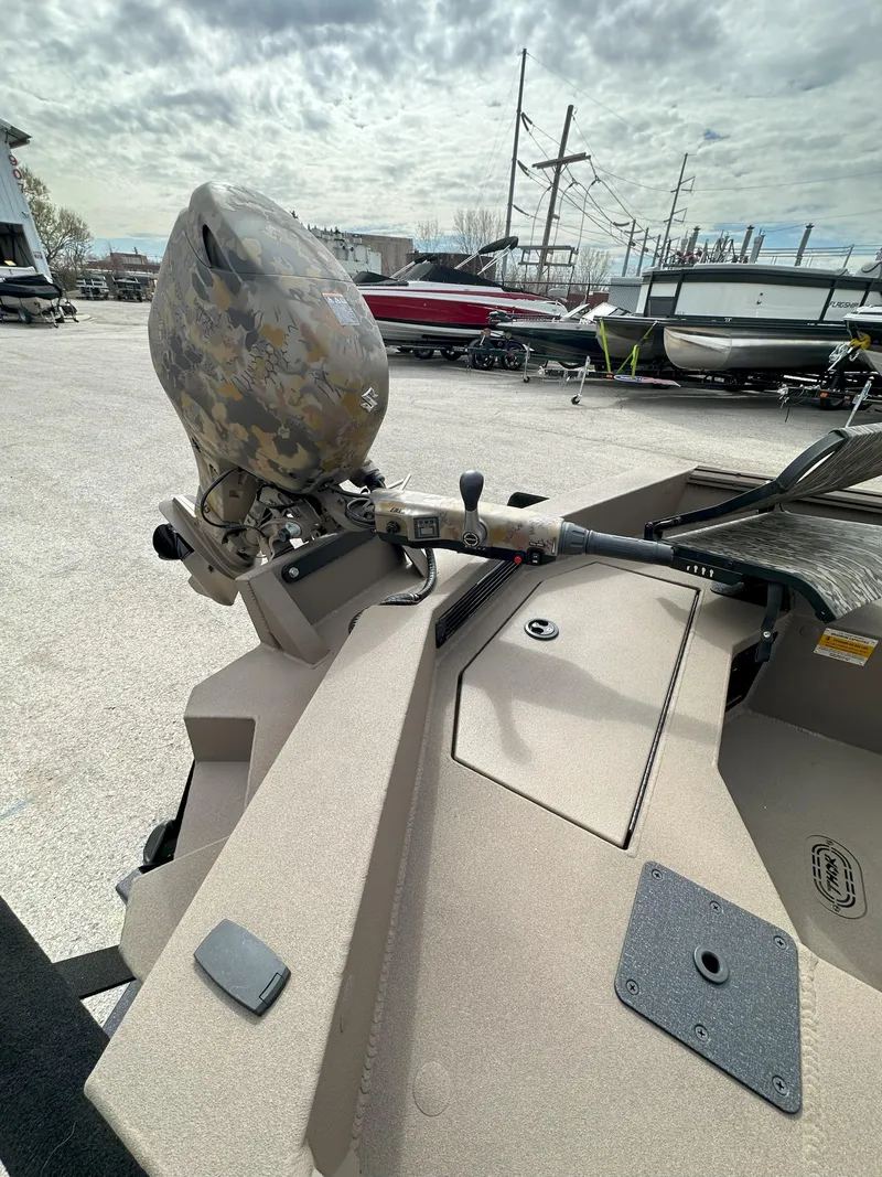 Slide: The Image of 2025 Thor 1754 Timber Hammer boat with camo motor, parked in a marina. - 11