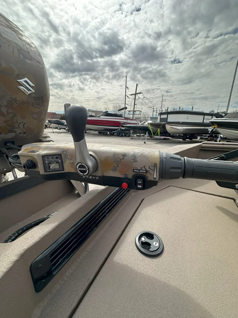 Slide: The Image of 2025 Thor 1754 Timber Hammer boat console with controls and steering wheel under cloudy sky. - 12