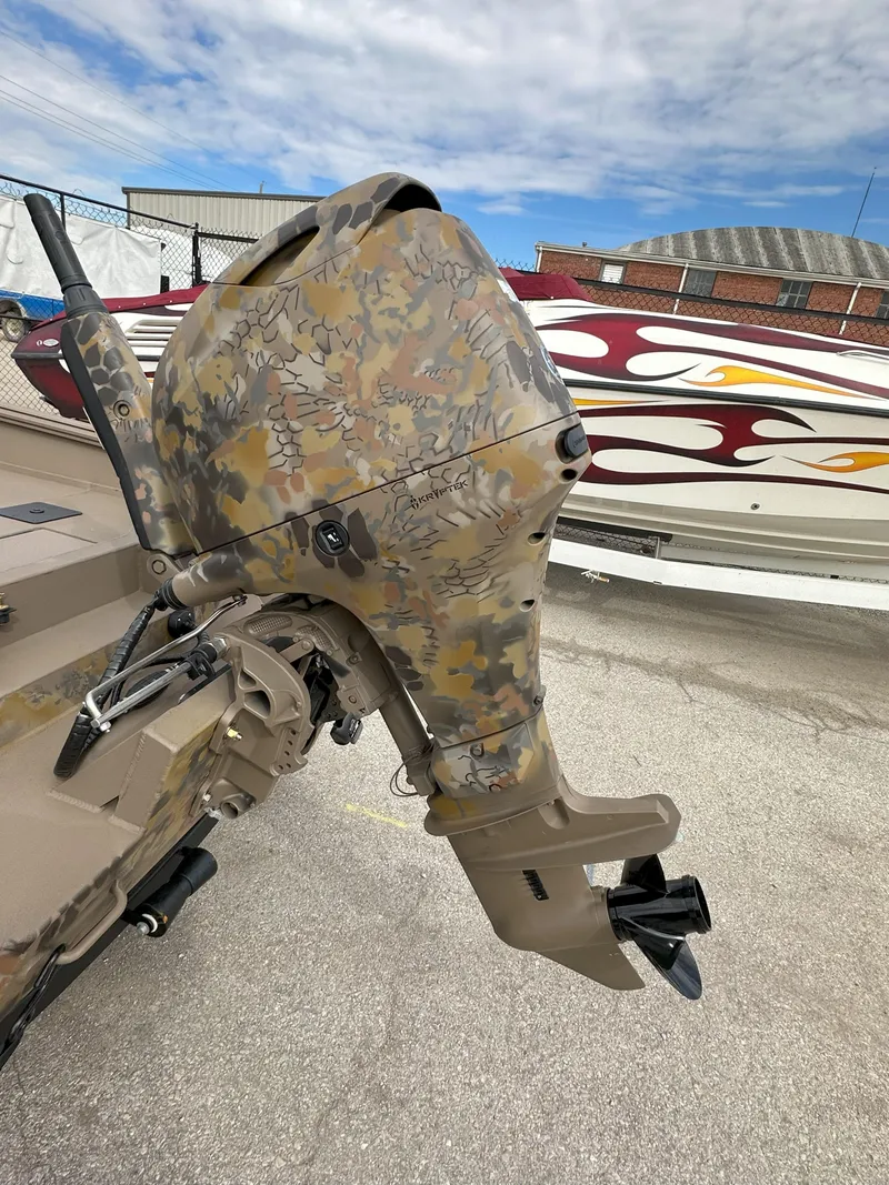 Slide: The Image of Camouflage-patterned Thor 1754 Timber Hammer outboard motor, 2025 model, mounted on a boat. - 3