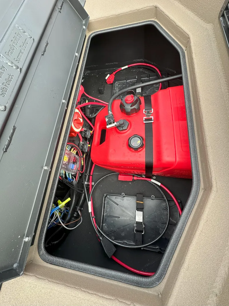 Slide: The Image of Storage compartment of 2025 Thor 1754 Timber Hammer with red fuel tank and wiring. - 6