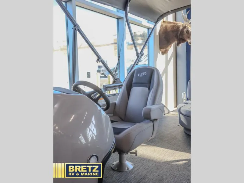 Slide: The Image of Aria Ultra-Lounge A22UC 2025 boat interior with steering wheel and comfortable seating. - 12