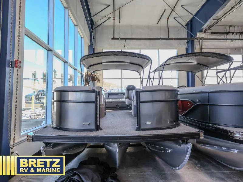 Slide: The Image of 2025 Aria Ultra-Lounge A22UC pontoon boat displayed at Bretz RV & Marine showroom. - 3