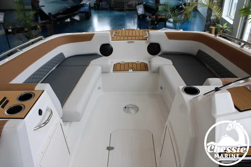Slide: The Image of 2025 Starcraft SVX 211 OB boat interior with cushioned seating and cup holders. - 3