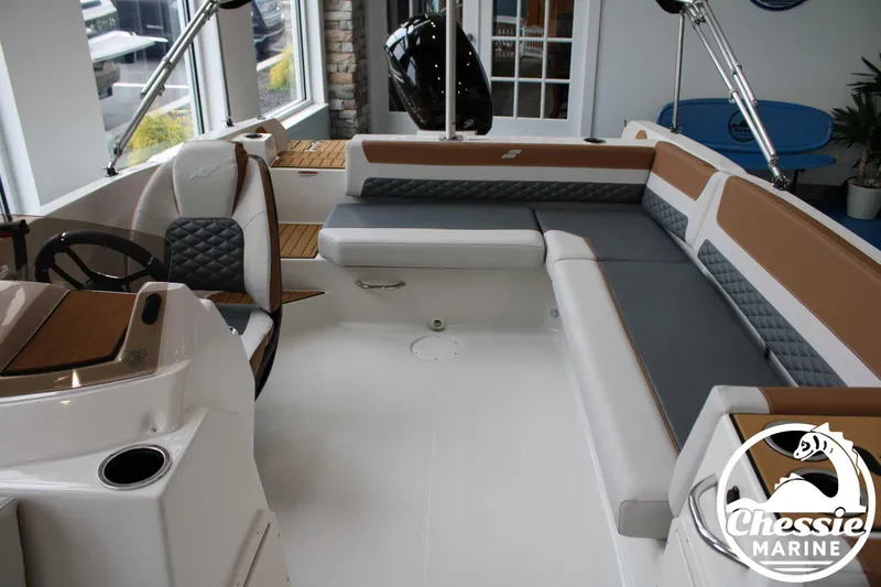 Slide: The Image of 2025 Starcraft SVX 211 OB boat interior with modern seating and steering wheel. - 4