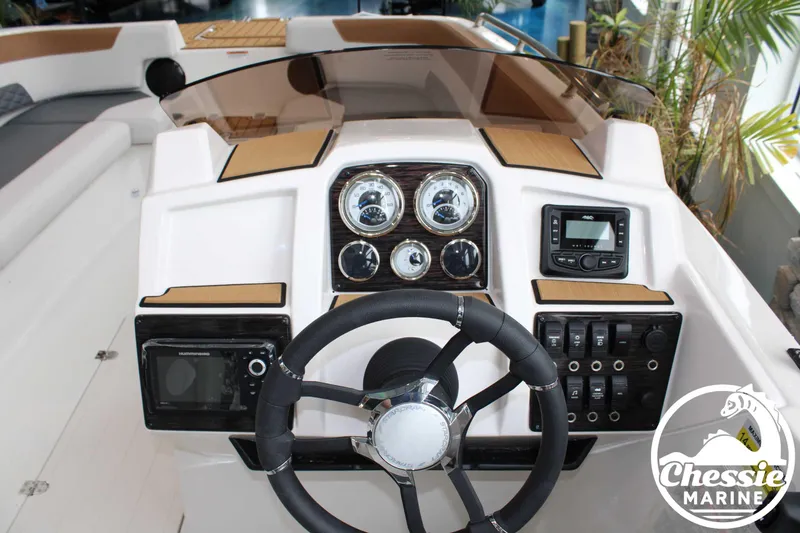 Slide: The Image of 2025 Starcraft SVX 211 OB boat dashboard with steering wheel, gauges, and control panel. - 7