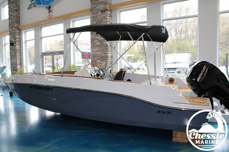 Slide: The Image of 2025 Starcraft SVX 211 OB boat displayed indoors at Chessie Marine showroom. - 8