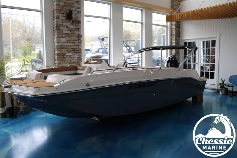 Slide: The Image of 2025 Starcraft SVX 211 OB boat displayed indoors at Chessie Marine showroom. - 9