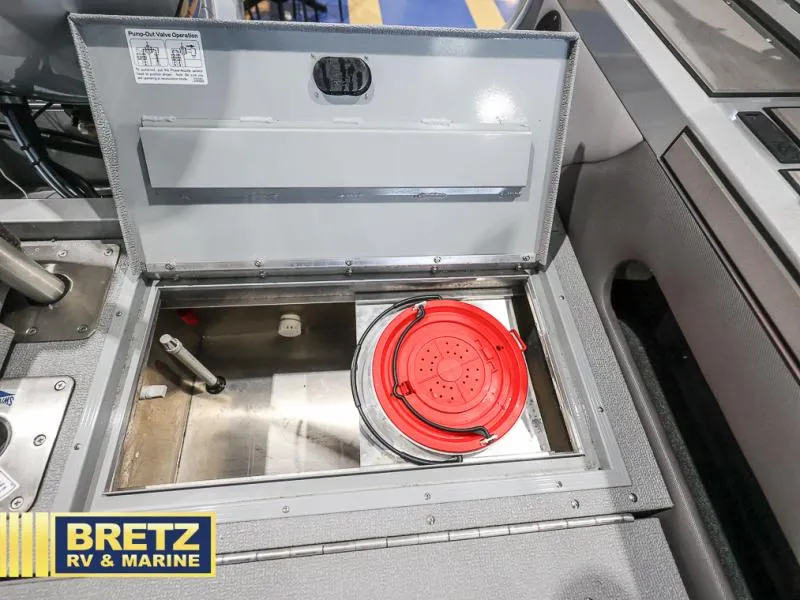 Slide: The Image of Open storage compartment in 2020 Pro Angler XL 182 XL boat with red lid, Bretz RV & Marine logo. - 22