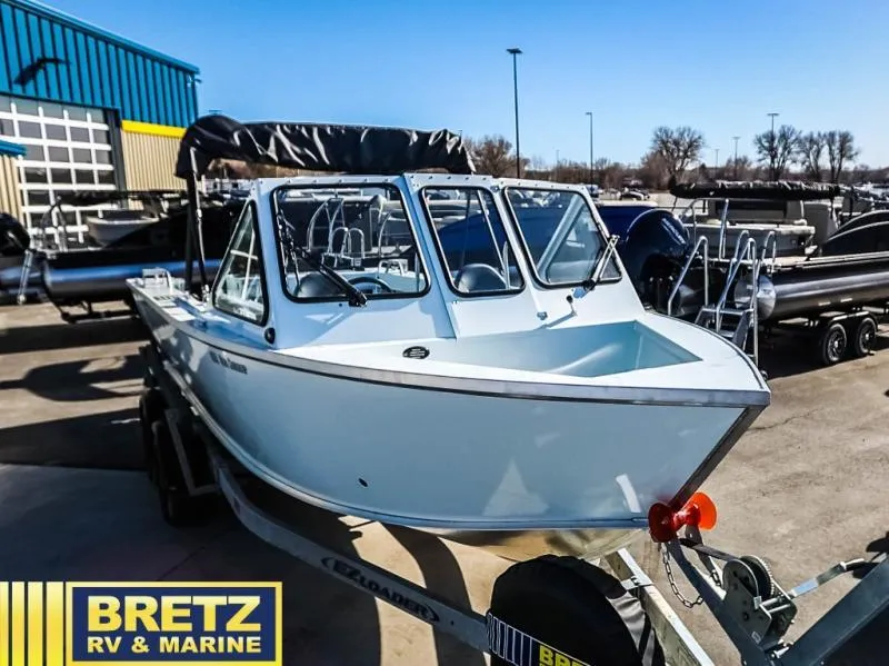 Slide: The Image of 2024 Sea Runner 210 SRET boat on trailer at Bretz RV & Marine dealership. - 1
