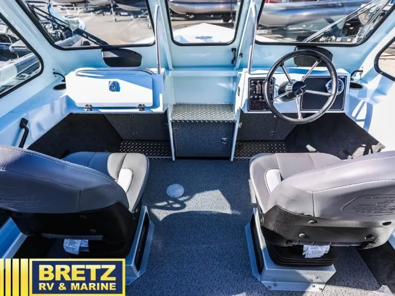 Slide: The Image of Interior of 2024 Sea Runner 210 SRET boat with steering wheel and seating. - 12