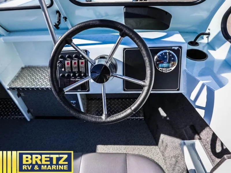 Slide: The Image of 2024 Sea Runner 210 SRET boat dashboard with steering wheel and control panel. - 15