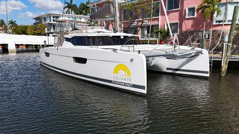 Slide: The Image of 2018 Fountaine Pajot Saona 47 catamaran docked in a scenic marina. - 1