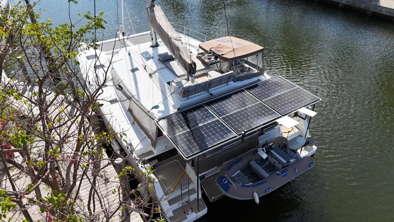 Slide: The Image of 2018 Fountaine Pajot Saona 47 catamaran with solar panels docked by the water. - 14