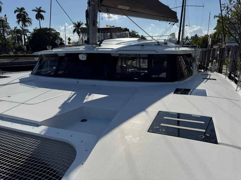 Slide: The Image of 2018 Fountaine Pajot Saona 47 catamaran docked, showcasing sleek design and spacious deck. - 17