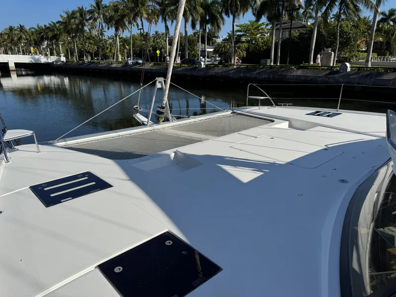 Slide: The Image of 2018 Fountaine Pajot Saona 47 catamaran docked by palm-lined canal. - 21