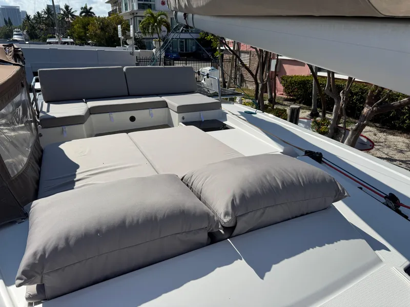 Slide: The Image of 2018 Fountaine Pajot Saona 47 yacht deck with cushioned seating and sunbathing area. - 26