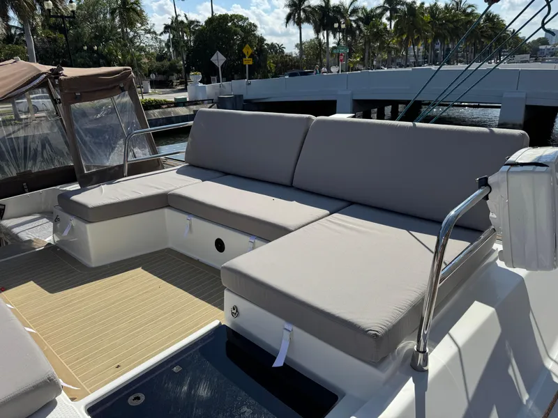 Slide: The Image of Luxurious seating area on 2018 Fountaine Pajot Saona 47 catamaran, docked near a scenic bridge. - 30