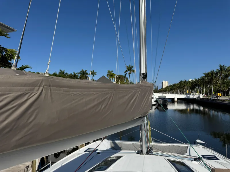 Slide: The Image of 2018 Fountaine Pajot Saona 47 catamaran docked by palm-lined waterway. - 31
